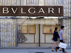 FILE - Shoppers walk past the Italian jewelry and luxury goods store, Bulgari in Beverly Hills, Calif, Thursday April 2, 2015. Italian luxury brand Bulgari is the latest international brand to apologize to China after listing Taiwan as a country on its website.