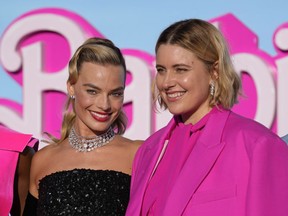 Margot Robbie, left, and writer/director/executive producer Greta Gerwig arrive at the premiere of "Barbie" on Sunday, July 9, 2023, at The Shrine Auditorium in Los Angeles.