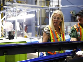 Catherine McKenna, minister of environment and climate change for Canada, center, speaks during a tour at the Magna International Inc. Polycon Industries auto parts manufacturing facility in Guelph, Ontario, Canada, on Aug. 30, 2018. Canadian stocks and the dollar extended gains Monday on news of a U.S.-Mexican trade agreement, shrugging off U.S. President Donald Trump's threats that Canada might be frozen out and instead face auto tariffs.