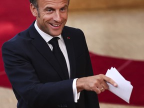 France's President Emmanuel Macron gestures as he talks to journalists during the third EU-CELAC summit that brings together leaders of the EU and the Community of Latin American and Caribbean States, in Brussels, Belgium, Tuesday, July 18, 2023.