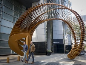Pedestrians walk past a sculpture outside the TC Energy head office in downtown Calgary, Alta., Friday, Sept. 16, 2022.THE CANADIAN PRESS/Jeff McIntosh