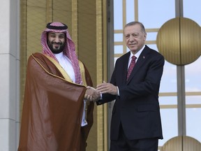 FILE - Turkish President Recep Tayyip Erdogan, right, and Saudi Crown Prince Mohammed bin Salman shake hands during a welcome ceremony, in Ankara, Turkey, Wednesday, June 22, 2022. Erdogan is beginning a three-stop tour of Gulf states to raise trade and investment for Turkey's floundering economy. The president will arrive in Jeddah, Saudi Arabia, on Monday, July 17, 2023, accompanied by an entourage of some 200 businesspeople. Business forums have been arranged in Saudi Arabia, Qatar and the United Arab Emirate.