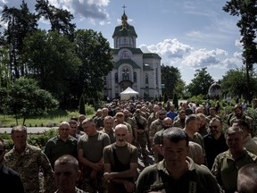Ukrainian servicemen attend a farewell ceremony of their fallen comrade Nicholas Maimer, a U.S. citizen and Army veteran who was killed during fighting in Bakhmut against Russian forces, in Ukrajinka, Ukraine, Wednesday, July 19, 2023.