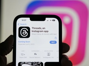The Threads app, operated by Meta Platforms Inc., on a smartphone, besides an Instagram Inc. logo, arranged in Madrid, Spain, on Tuesday, July 5, 2023. Threads is a "text-based conversation app" that's widely seen as an alternative to Twitter.