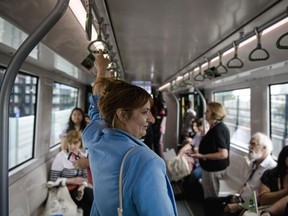 Visitors ride the Reseau Express Metropolitain light rail during its inauguration ceremony in Montreal on Friday.