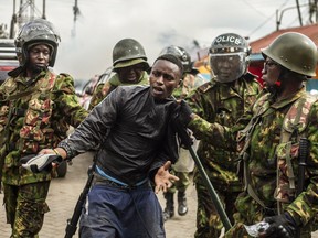Kenyan police arrest a protester in the Kibera neighborhood of Nairobi, Kenya, Wednesday, July 12, 2023. Anti-government protesters are demonstrating in a number of Kenyan cities against newly imposed taxes and the cost of living.