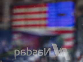 An American flag is reflected in the window at the Nasdaq MarketSite in New York.