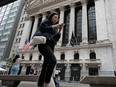 People walking by the New York Stock Exchange.