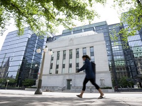 A woman walks past the Bank of Canada headquarters in Ottawa.