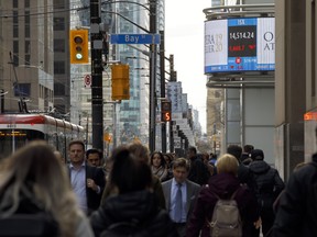 The TSX is shown on a business news ticker in the financial district in Toronto.