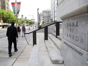 Pedestrians walk past the Bank of Canada in Ottawa.