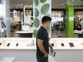 A customer browses smartphones at a Telus Corp. store in Toronto.