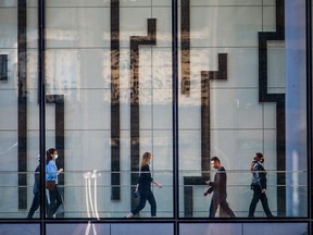 Office workers walk through Brookfield Place in downtown Calgary.
