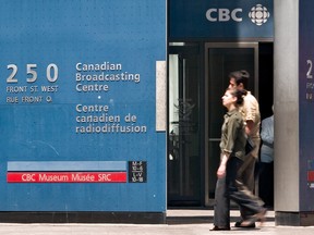 Pedestrians walk in front of the CBC building in downtown Toronto.