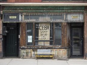 A storefront with the message "CEBA won't save us" in Toronto.
