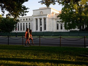 Pedestrians walk past the US Federal Reserve Bank in Washington, DC.