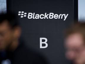 Employees walk past the BlackBerry Ltd. headquarters in Waterloo, Ont.
