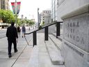 Pedestrians walk past the Bank of Canada in Ottawa.