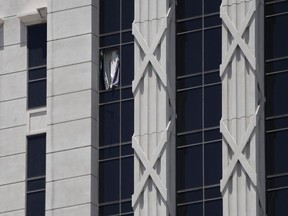 A curtain hangs out of a broken window on a hotel tower at Caesars Palace Hotel & Casino, Tuesday, July 11, 2023, in Las Vegas.