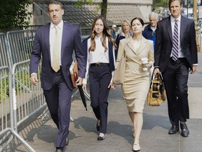 FILE - Charlie Javice, second from left, founder of a student loan assistance startup company charged with fraud, arrives at federal court with her legal team, June 6, 2023, in New York. Frank shook her head repeatedly Thursday, July 13, as a prosecutor claimed that she snookered J.P. Morgan Chase into paying $175 million for her business by lying about its client base.