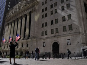 FILE - A visitor take a photo of the New York Stock Exchange, Friday, Sept. 23, 2022, in New York.