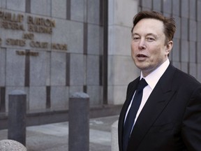 FILE - Elon Musk leaves the Phillip Burton Federal Building and United States Court House in San Francisco, Tuesday, Jan. 24, 2023. A federal appeals court Friday, July 21, said it will reconsider its March ruling that Musk unlawfully threatened employees with a loss of stock options in a 2018 Twitter post amid an organizing effort by the United Auto Workers union.