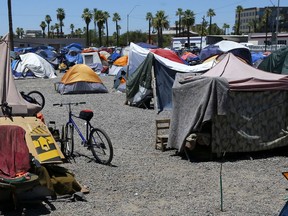 FILE - A large homeless encampment is shown in Phoenix, on Aug. 5, 2020. The city of Phoenix is scheduled go to court Monday, July 10, 2023, to prove it has met a deadline to clear a large homeless encampment, an action that has drawn pushback from civil rights advocates.