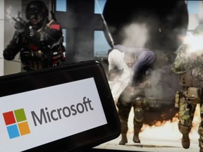 File - The logo for Microsoft, and a scene from Activision "Call of Duty - Modern Warfare," are shown in this photo, in New York, Wednesday, June 21, 2023. A judge handed Microsoft a big victory on Tuesday, declining to stop its $69 billion takeover of video game maker Activision Blizzard.