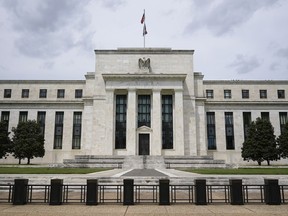 FILE - An American flag flies over the Federal Reserve building on May 4, 2021, in Washington. The Federal Reserve has launched their instant payment service, FedNow, which allows banks and credit unions to sign up to send real-time payments between them.