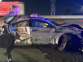 This image released by the Connecticut State Police, Tuesday, July 18, 2023, shows one of of two state police cruisers damaged when human waste, leaking from a tractor trailer, turned Interstate 95 in Bridgeport, Conn., into a virtual skating rink, causing multiple crashes, Monday night, July 17, 2023. State police charged the driver with reckless driving, reckless endangerment and failing to secure a load. (Connecticut State Police via AP)