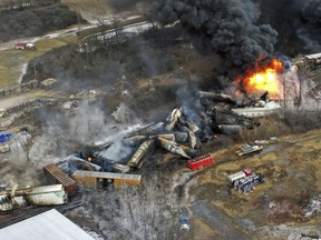 FILE - In this photo taken with a drone, portions of a Norfolk Southern freight train that derailed the previous night in East Palestine, Ohio, remain on fire at mid-day, Feb. 4, 2023. Norfolk Southern says the owner of the rail car that caused the fiery Ohio derailment in February failed to properly maintain it in the years before the crash, and the railroad wants to make sure that company and the owners of the other cars involved pay their fair share of the costs. The railroad filed a complaint Friday, June 30, against all the car owners and shippers responsible for the hazardous chemicals that spilled in the derailment.