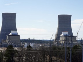 FILE - Units 3, left, and 4 and their cooling towers stand at Georgia Power Co.'s Plant Vogtle nuclear power plant, Jan. 20, 2023, in Waynesboro, Ga. Federal nuclear regulators announced on Friday, July 28, that they had cleared Georgia Power and its co-owners to load radioactive fuel into Unit 4, shown at right, the second of two new reactors on the site.