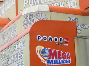 FILE - The awnings of a store advertise the sale of lottery tickets, including Mega Millions, Wednesday, Jan. 11, 2023, in New York. The Mega Millions prize has grown to an estimated $1.05 billion for the Tuesday, Aug. 1, 2023, drawing.