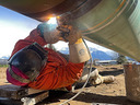 A welder joins together sections of pipe on the Trans Mountain pipeline expansion. The expanded Trans Mountain pipeline will enter service early next year after nearly tripling its capacity, delivering an extra 590,000 barrels of Alberta oil each day to Vancouver.