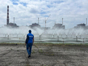 This handout photo taken and retrieved from the imagebank of International Atomic Energy Agency (IAEA) on June 15, 2023 shows a member of the agency walking near the Zaporizhzhia Nuclear Power Plant in Enerhodar, Zaporizhzhia Oblast, Ukraine during an official visit.