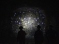 Workers inspect a wall containing minerals and metals at the Vale Copper Cliff mine in Sudbury, Ont.