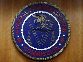 FILE - The seal of the Federal Communications Commission (FCC) is seen before an FCC meeting to vote on net neutrality in Washington, Dec. 14, 2017. The Biden administration and major consumer tech players are launching an effort to put a nationwide cybersecurity certification and labeling program in place to help consumers choose smart devices that are less vulnerable to hacking. Officials liken the new "U.S. Cyber Trust Mark" initiative to the Energy Star program that rates appliances' energy efficiency. It will be overseen by the Federal Communications Commission.