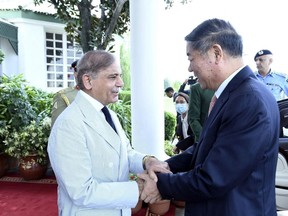 In this handout photo released by Pakistan Prime Minister's Office, Pakistan's Prime Minister Shehbaz Sharif, left, greets Chinese Vice Premier He Lifeng, in the Prime Minister house in Islamabad, Pakistan, Monday, July 31, 2023. (Pakistan Prime Minister's Office via AP)