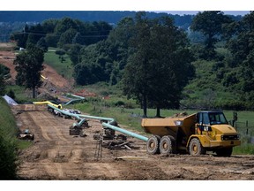 Sections of pipe and a Caterpillar Inc. truck sit at an Energy Transfer Partners LP construction site for the Sunoco Inc. Mariner East 2 natural gas liquids pipeline project near Morgantown, Pennsylvania, U.S. on Aug. 4, 2017. The Pennsylvania Department of Environmental Protection has issued four notices of violation after "inadvertent" spills of drilling fluids associated with horizontal directional drilling for the project.
