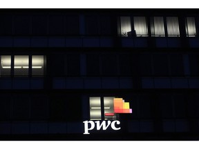 A logo sits illuminated on the offices of Pricewaterhouse Coopers International Ltd. (PwC) in Stuttgart, Germany, on Thursday, Jan. 25, 2018. Germany's Federal Administrative Court in February will rule on a potential diesel ban in Stuttgart, with consequences likely for other polluted cities. Photographer: Krisztian Bocsi/Bloomberg