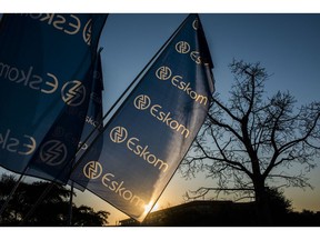 Company flags fly outside the Eskom Holdings SOC Ltd. Megawatt Park headquarters office in Johannesburg, South Africa, on Tuesday, July 30, 2019. Eskom reported a record loss of 20.7 billion rand.