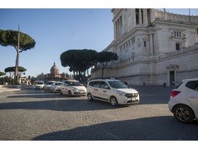 Taxis wait for customers along the Roman Forum near Piazza Venezia in Rome, Italy, on Wednesday, March 11, 2020. Italian Prime Minister Giuseppe Conte's government is ready to spend as much as 25 billion euros ($28.3 billion) on stimulus measures to shield the economy from Europe's worst outbreak of the coronavirus.