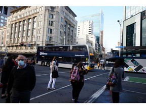 Commuters wait at a junction in Auckland, New Zealand, on Wednesday, Sept. 16, 2020. New Zealand's economy will endure a shallower recession than previously expected but the coronavirus pandemic will have a longer impact on the country's finances, according to government projections.