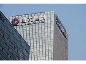 The China Evergrande Group logo displayed atop the company's headquarters in Shenzhen, China, on Thursday, Sept. 30, 2021. China Evergrande Group started returning a small portion of the money owed to buyers of its investment products, weeks after people protested against missed payments.