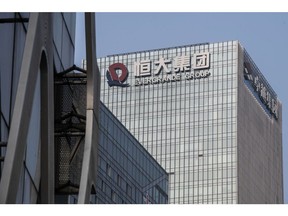 The China Evergrande Group logo displayed atop the company's headquarters in Shenzhen, China, on Thursday, Sept. 30, 2021. China Evergrande Group started returning a small portion of the money owed to buyers of its investment products, weeks after people protested against missed payments.