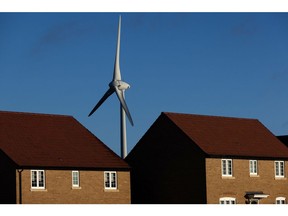 A wind turbine near residential houses near Burton Latimer, UK, on Wednesday, Dec. 14, 2022. UK power prices for Monday jumped to record levels as freezing temperatures are set to cause a surge in demand, just as a drop in wind generation causes a supply crunch. Photographer: Chris Ratcliffe/Bloomberg