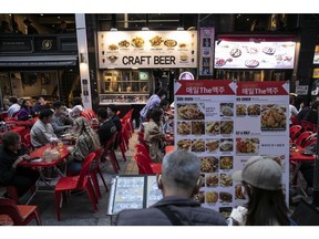 Customers dine at an outdoor restaurant in the Myeongdong shopping district in Seoul, South Korea, on Saturday, April 22, 2023. South Korea's economy likely skirted close to a recession at the start of the year, according to a Bloomberg survey, as slower global growth stunted exports and renewed currency weakness helped inflate the country's import bill. Photographer: Woohae Cho/Bloomberg