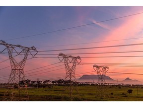 Table Mountain beyond high-voltage electricity transmission towers in Cape Town, South Africa, on Thursday, June 1, 2023. Cape Town, South Africa's second-largest city, is in talks with Eskom Holdings SOC Ltd. to take over the supply of electricity in areas of the metro served by the state power utility.