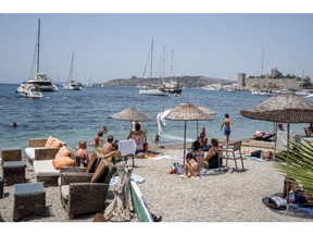 Tourists on the beach in Bodrum, Turkey, on Thursday, July 6, 2023. The lira has lost 28% of its value so far this year, the biggest decline among 31 major currencies tracked by Bloomberg, after the Argentine peso.
