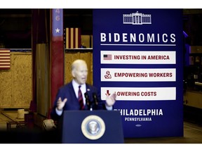 A Bidenomics sign behind US President Joe Biden during an event at Philly Shipyard in Philadelphia, Pennsylvania, US, on Thursday, July 20, 2023. Biden's rebranding of his economic policies has largely failed to convince the public that key aspects of the economy are significantly improving, according to a poll released Wednesday by the Monmouth University Polling Institute. Photographer: Hannah Beier/Bloomberg